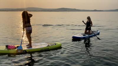 Paddle boarders watch a tuna