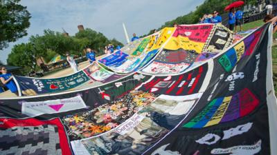 Volunteers place panels of the AIDS Memorial Quilt on the National Mall in Washington DC