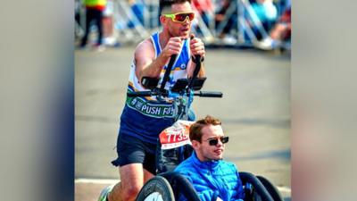 Sean McQuaid pushed his teammate Riley Pathman in a specially-adapted chair