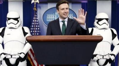 White House Press Secretary Josh Earnest appears in the briefing room with Star Wars Stormtroopers and Robot R2-D2