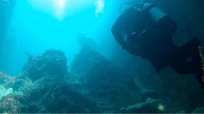 A group of divers filmed themselves diving into a sea cave off the Dorset coast near Durdle Door