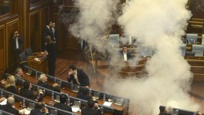 Opposition MPs throw tear gas during a session of Kosovo's parliament