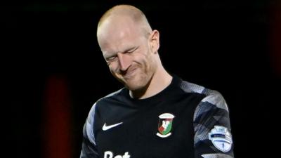 Glentoran goalkeeper Aaron McCarey leaves the pitch