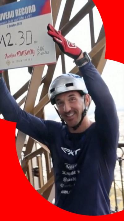 Aurélien Fontenoy smiling and holding up his world record time on a board