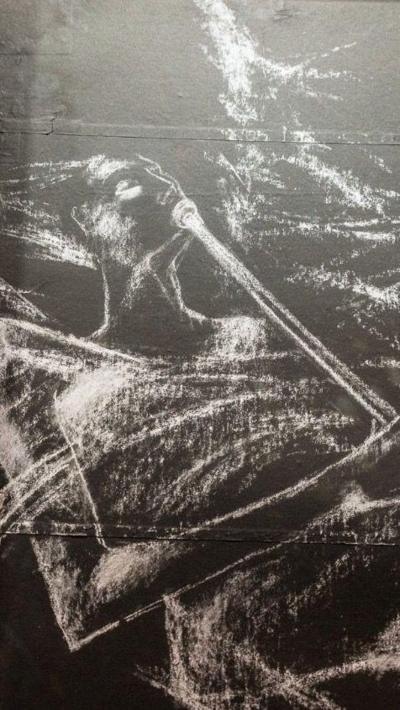 Chalk drawing of an angel on black paper