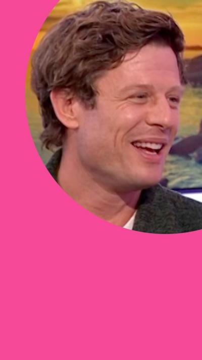 James Norton smiles while looking to his left