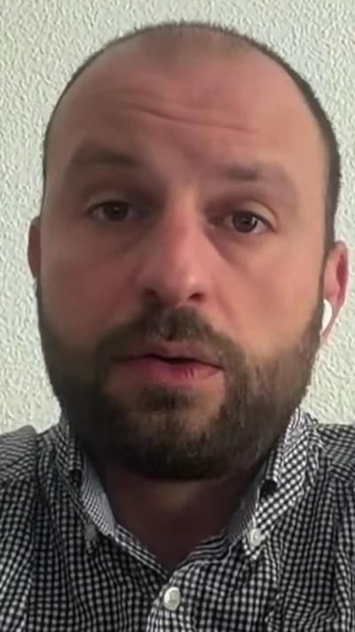 Alessio Ghirlanda on a Zoom call in front of a white wall