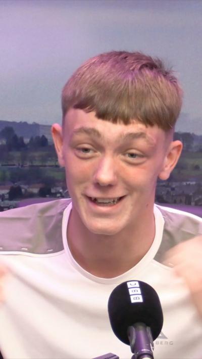 Young man with short light hair in a white tee-shirt