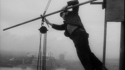 Steeplejack balancing precariously at 400 ft