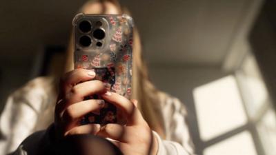 A girl looks at her smartphone