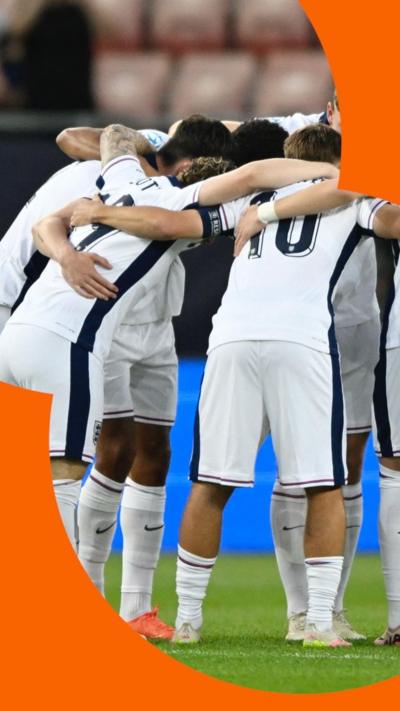 Group of footballers in a huddle.