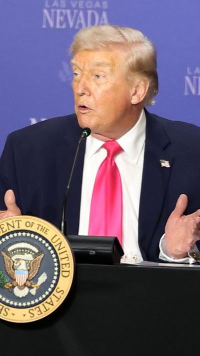 Donald Trump sat down in front of microphone during press conference