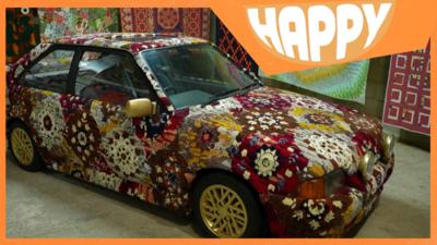 A car covered in carpet and the Happy logo