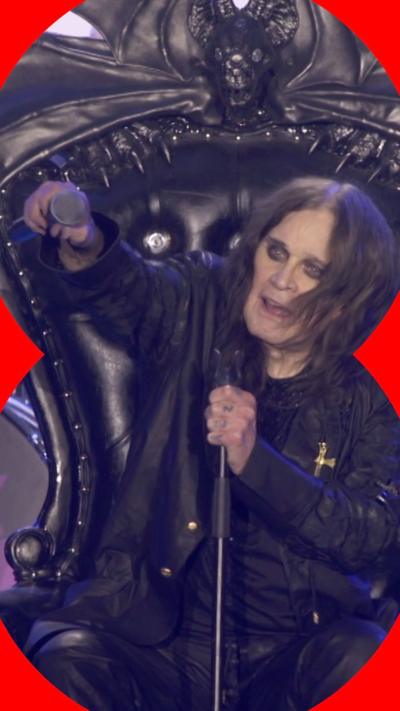 Ozzy Osbourne, who wears all black and has long brown hair and heavy eyeliner, sits on a throne onstage
