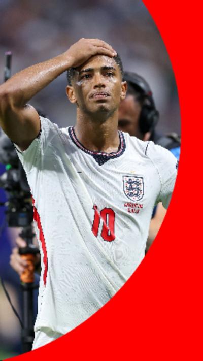 Jude Bellingham with his right hand on his forehead, wearing the England kit