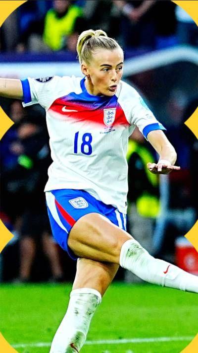 Chloe Kelly, in an England kit, kicks the ball on the pitch