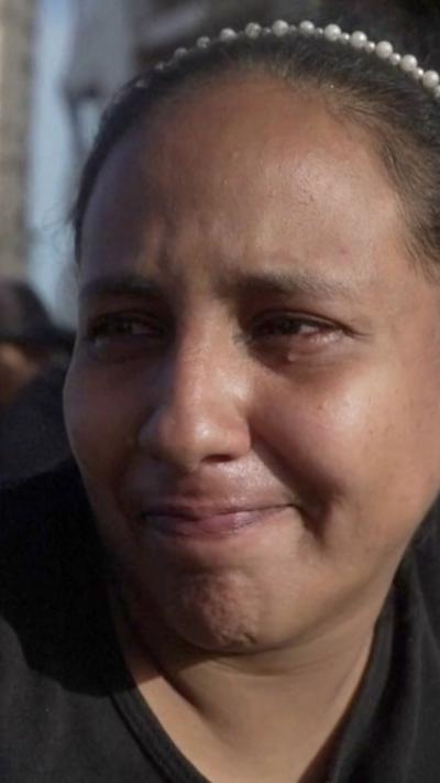 Close-up of woman, who lives in La Guaira, crying as she describes devastation