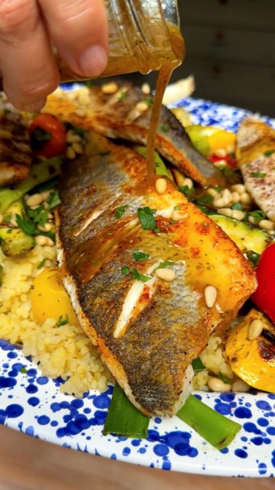 Dressing pouring over sea bass. 