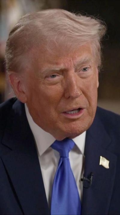 Donald Trump, who has combed over light blonde hair, wears a suit and tie during the interview