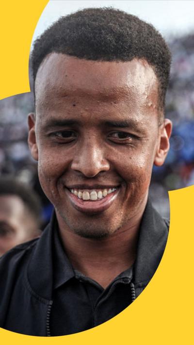 Somali international referee Omar Abdulkadir Artan smiles as he is welcomed by supporters 