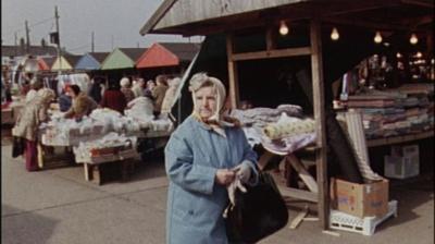 Woman walks through a market