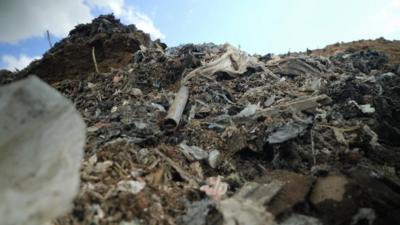 A huge pile of rubbish and some sky.