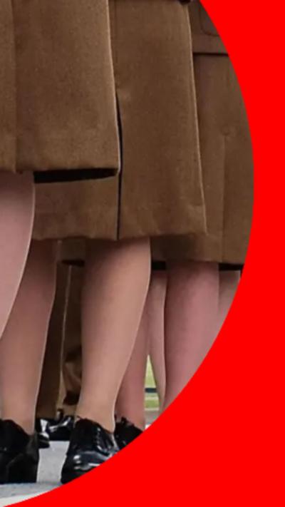 Female forces members wearing skits standing in a line.