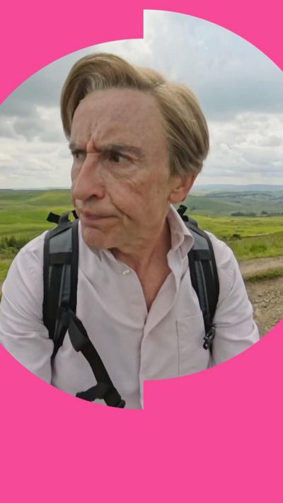 Steve Coogan character Alan Partridge standing on a hill looking quizzically to his side