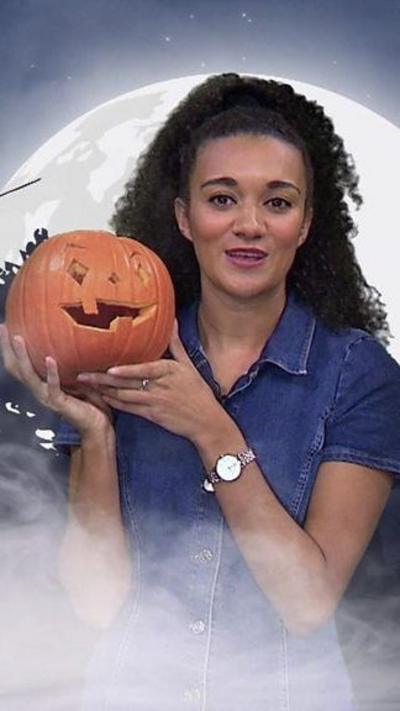 Nina holding a Halloween pumpkin