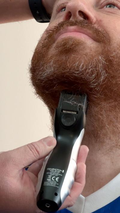 Leicester fan Eli has his beard shaved.