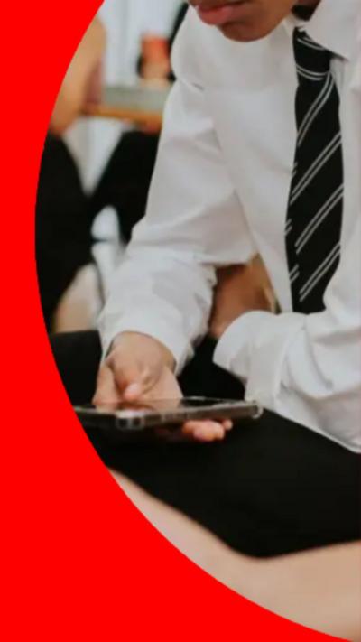 Pupils in school uniform shirt and tie on phones.