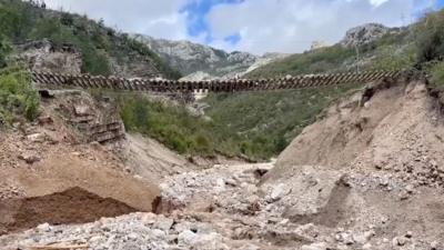 Train track left suspended in the air after landslides