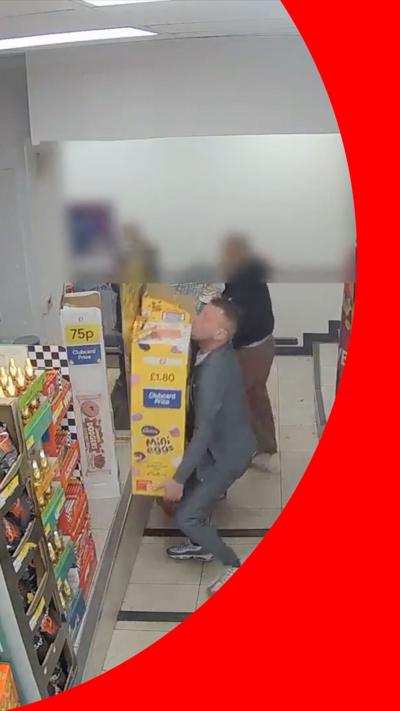 A man lifting a mini eggs display 