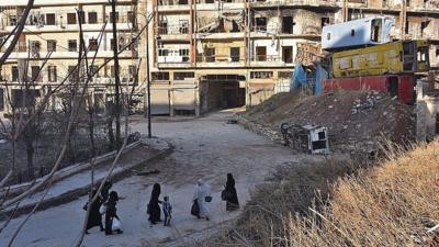 Syrian residents fleeing the violence in the eastern rebel-held parts of Aleppo