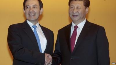 Taiwanese President Ying-jeou (L) and Chinese President Xi Jinping (R) shake hands