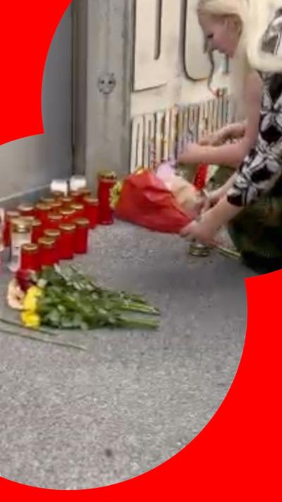 A woman laying flowers