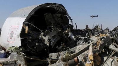 An Egyptian military helicopter flies over debris from a Russian airliner which crashed at the Hassana area in Arish city, north Egypt, in this file photograph dated November 1, 2015