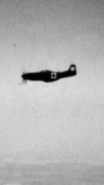 A grainy black and grey image of a German Luftwaffe aircraft flying through the air.