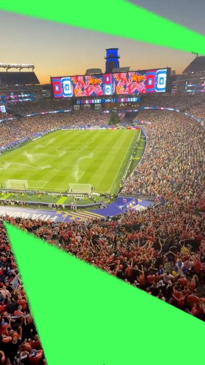 A wide shot of Boston Stadium filled with Scotland fans in blue and orange football strips.