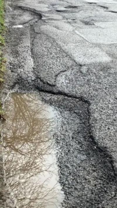 A pothole filled with rain water.