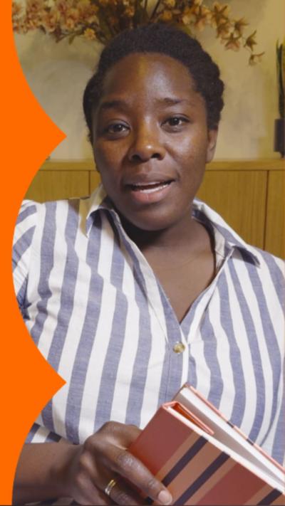 A woman with short, dark hair speak to the camera