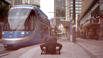 Act of prayer at a Midland Metro tram stop