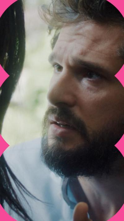 A bearded man looks desperately into a woman's eyes.