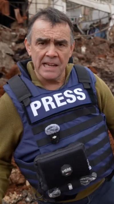 Wyre Davies, wearing a buillet-proof vest with Press written on it