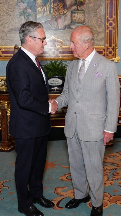 Sir Keir Starmer shaking hands with the King