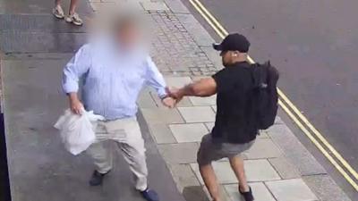 A man fighting off watch muggers with a takeaway bag