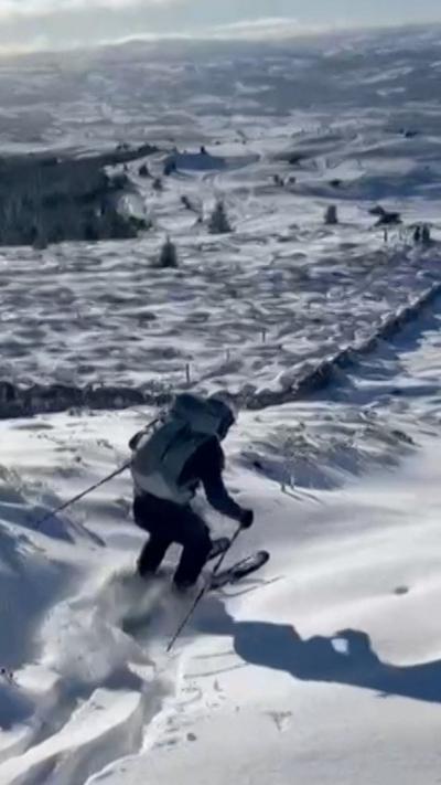 A person is seen skiing