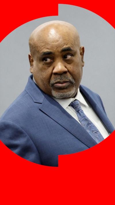 A man in a blue suit and tie.