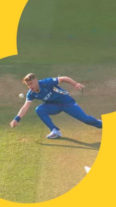 Sam Curran reaches to catch the ball, but it bounces off of his temple instead