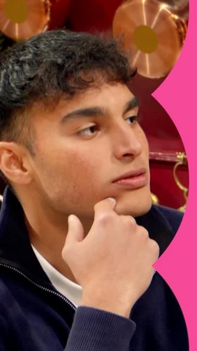 Faraaz from The Traitors with his hand held up towards his face